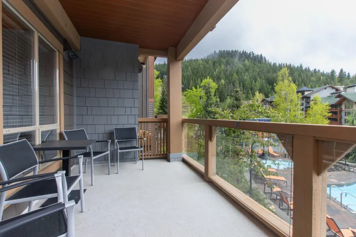Balcony featuring a view of trees