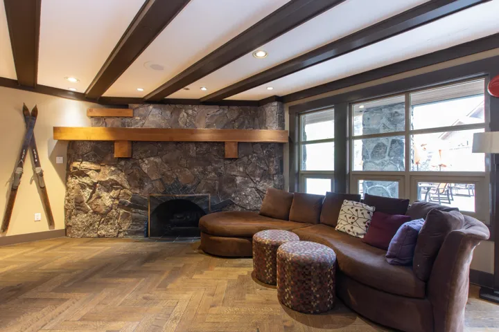 Living area featuring beamed ceiling and baseboards