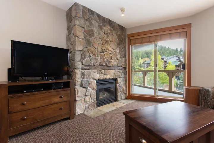 Living room with a fireplace and carpet flooring
