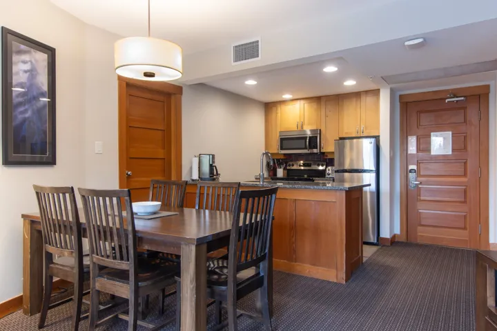 Dining space with dark colored carpet, baseboards, and recessed lighting