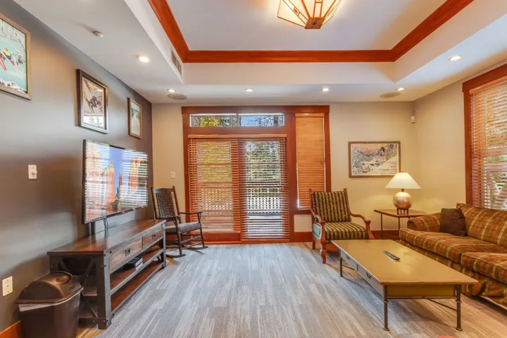 Sitting room featuring a tray ceiling, crown molding, recessed lighting, and light wood finished floors
