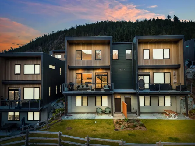 Modern multi-level exterior featuring wood-finish siding and dark panel accents