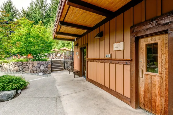 Doorway to property featuring board and batten siding and a patio area