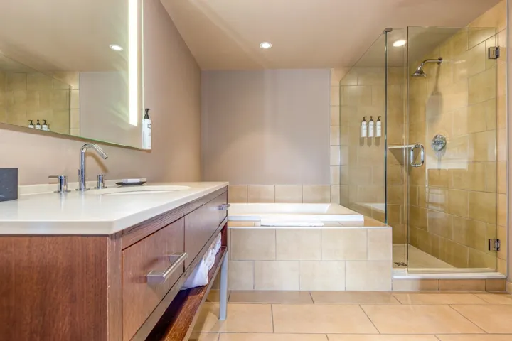 Full bath with vanity, light tile patterned floors, a shower stall, a garden tub, and recessed lighting