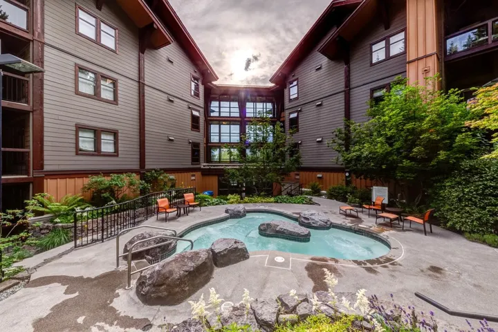 View of swimming pool featuring a patio area and a hot tub