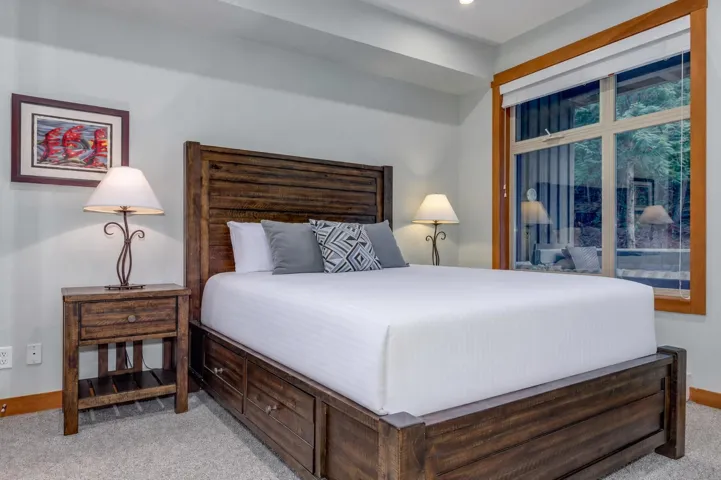 Wood-finish bed frame with integrated drawers, complemented by a coordinating nightstand
