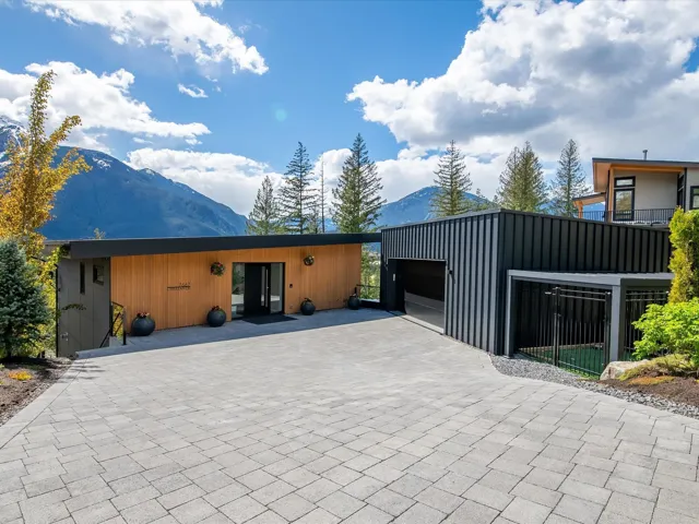 View of front facade with a mountain view, decorative driveway, and an attached garage