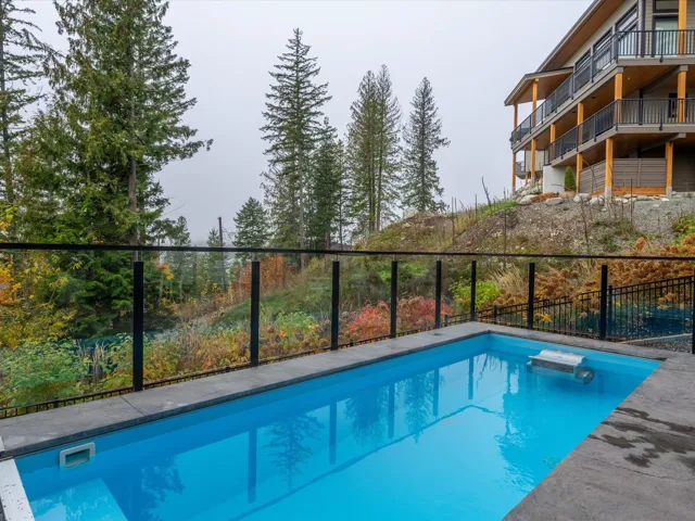 View of swimming pool with a diving board