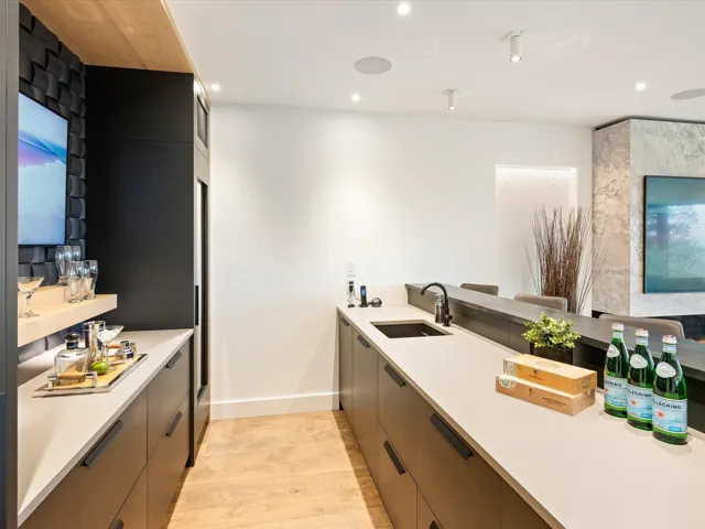 Kitchen featuring light wood-style floors, modern cabinets, a peninsula, recessed lighting, and light stone countertops
