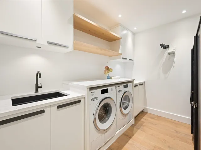 Bedroom with wood finished floors, recessed lighting, and ensuite bath