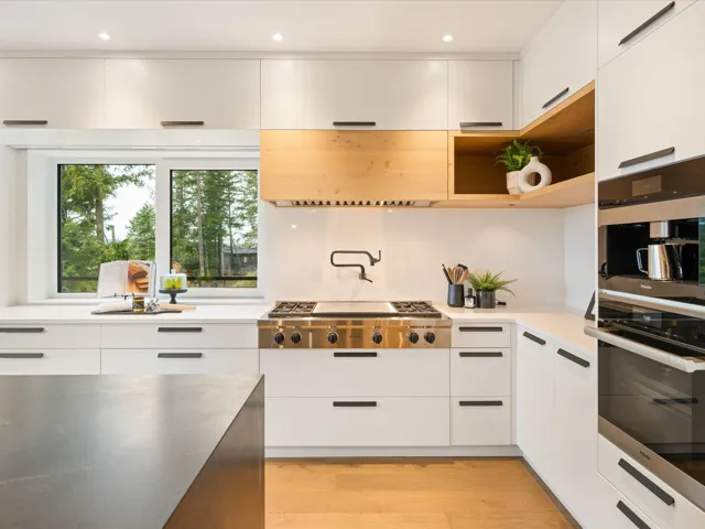 Kitchen with modern cabinets, white cabinets, appliances with stainless steel finishes, light wood-style floors, and recessed lighting