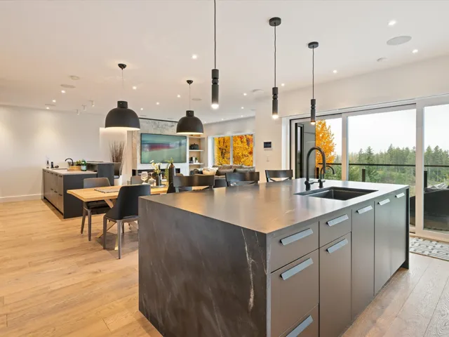Kitchen with decorative light fixtures, modern cabinets, light wood finished floors, open floor plan, and recessed lighting