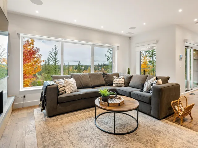 Living room with light wood-style flooring and recessed lighting