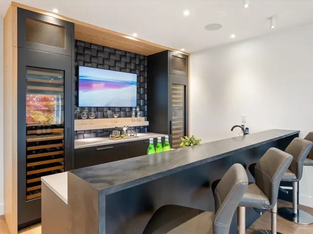 Indoor wet bar with light wood-type flooring, beverage cooler, recessed lighting, and modern cabinets