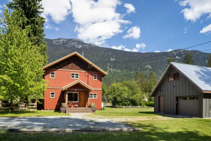 Red siding residence with a covered porch and wood-finish steps