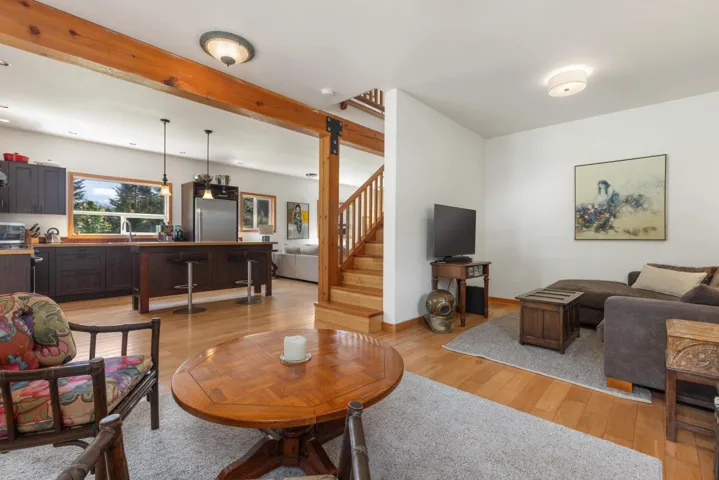 Open concept living space featuring wood-finish flooring