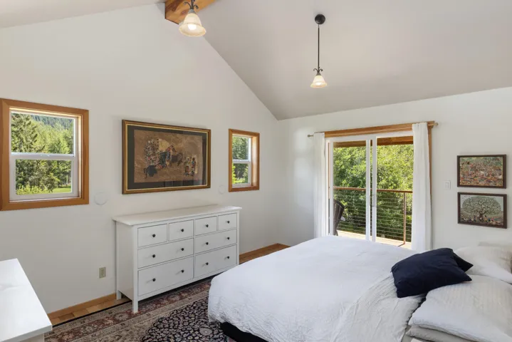 Vaulted ceiling with exposed wood beam and two pendant light fixtures