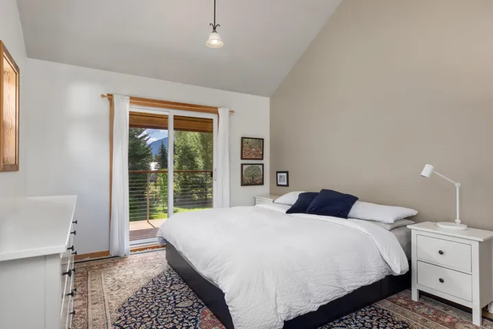 Room featuring a vaulted ceiling and direct access to an exterior balcony