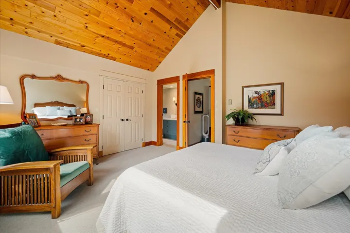 Vaulted wood-paneled ceiling with light-toned walls