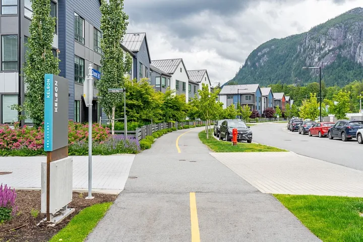 View of asphalt street with a residential view, a mountain view, and street lighting