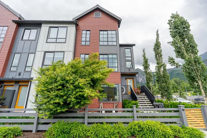 Modern home featuring a fenced front yard and stairway