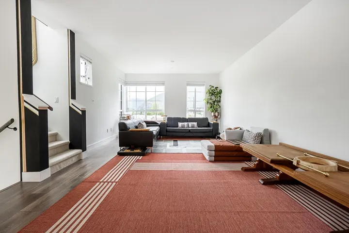 Living room featuring stairway and wood finished floors