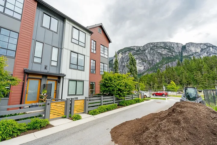 View of property with a fenced front yard and a mountain view