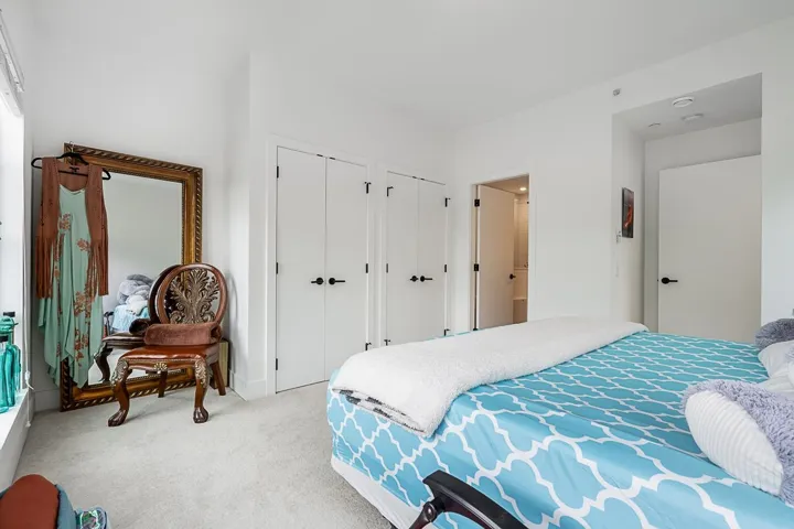 Carpeted bedroom featuring two closets