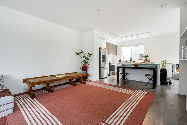 Living room with dark wood-type flooring and rail lighting