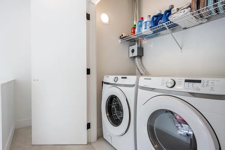 Laundry area with washer and dryer and baseboards
