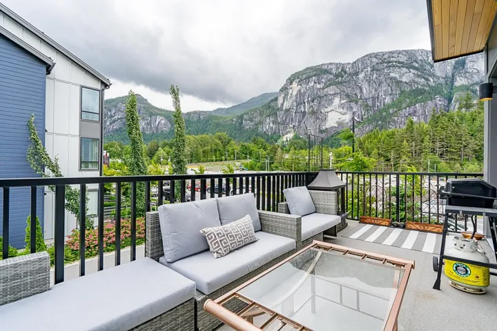Balcony featuring an outdoor hangout area, a grill, and a mountain view
