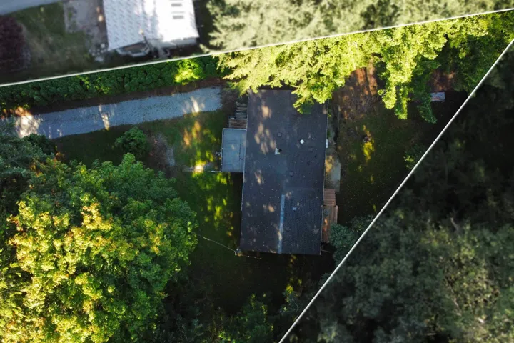 Aerial view of property and surrounding area with property parcel outlined