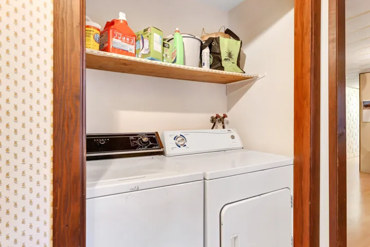 Washroom with washing machine and clothes dryer