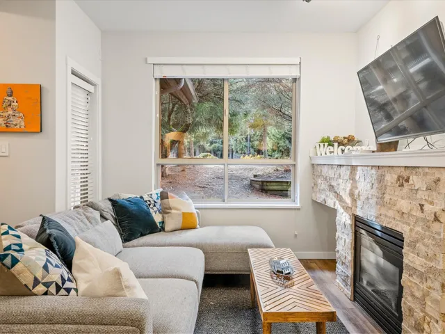Living area featuring wood finished floors and a fireplace