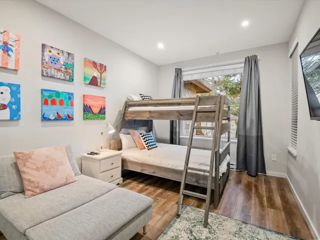 Bedroom with wood finished floors and recessed lighting