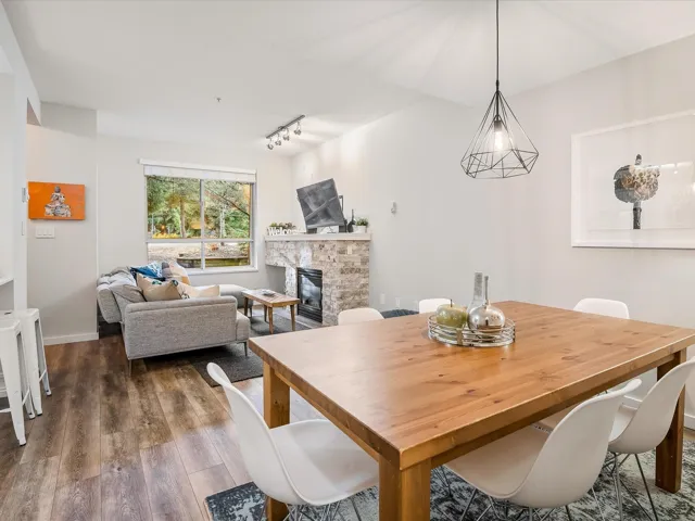 Dining space featuring a fireplace, dark wood-type flooring, and rail lighting