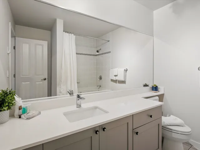 Bathroom with vanity and shower / bath combination with curtain