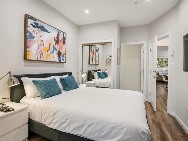 Bedroom featuring dark wood-style flooring, a closet, and recessed lighting