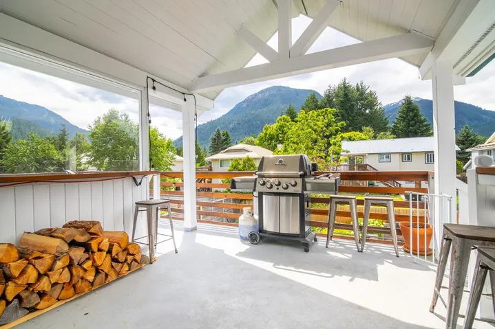 View of patio / terrace featuring a mountain view, grilling area, and an outdoor bar