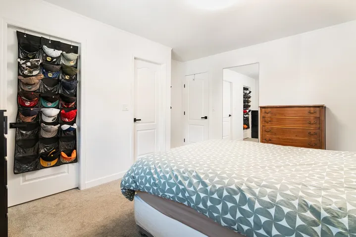 Bedroom with carpet floors and crown molding