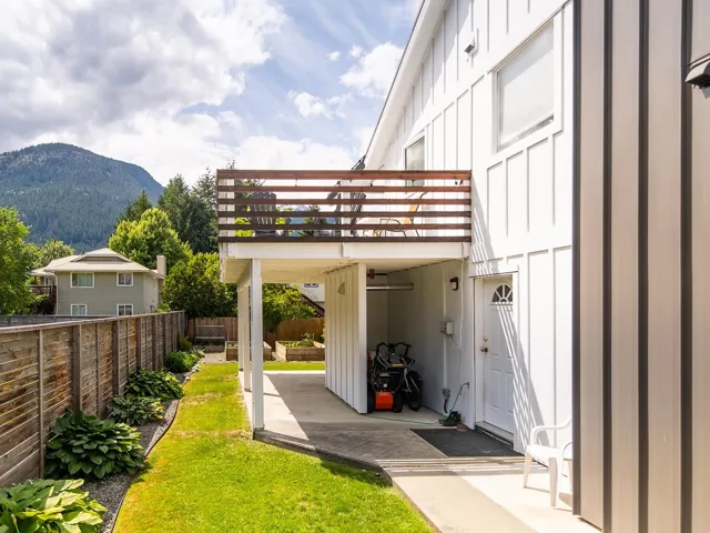 View of vehicle parking with a mountain view and a fenced backyard