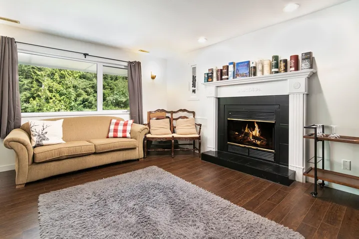 Living room featuring wood finished floors, a fireplace, and recessed lighting