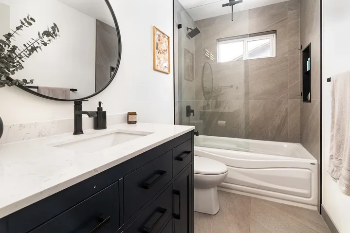 Bathroom featuring vanity and shower / bathtub combination