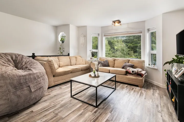 Living room with light wood-style floors and baseboards
