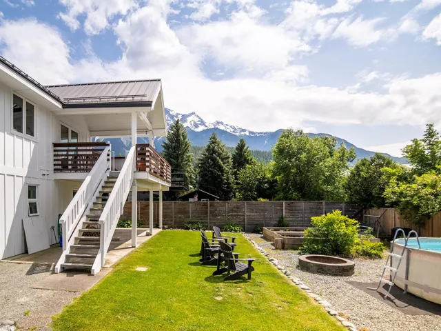 Fenced backyard featuring a garden, a mountain view, and stairs