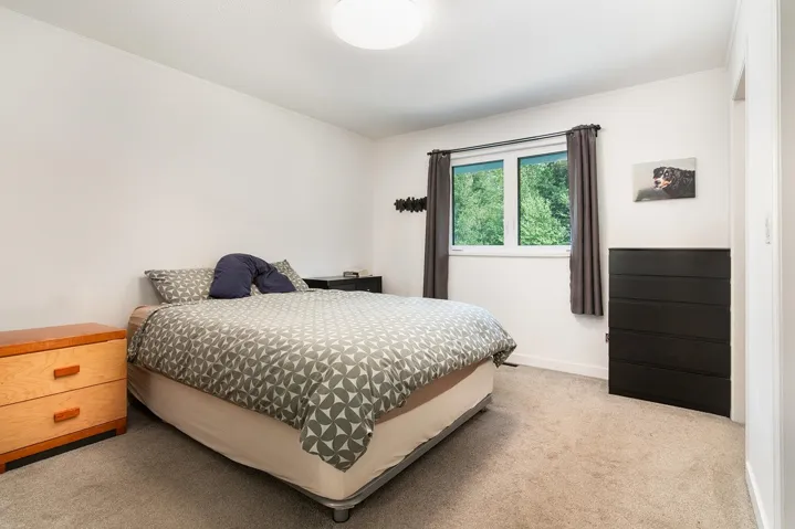 Bedroom with carpet and crown molding