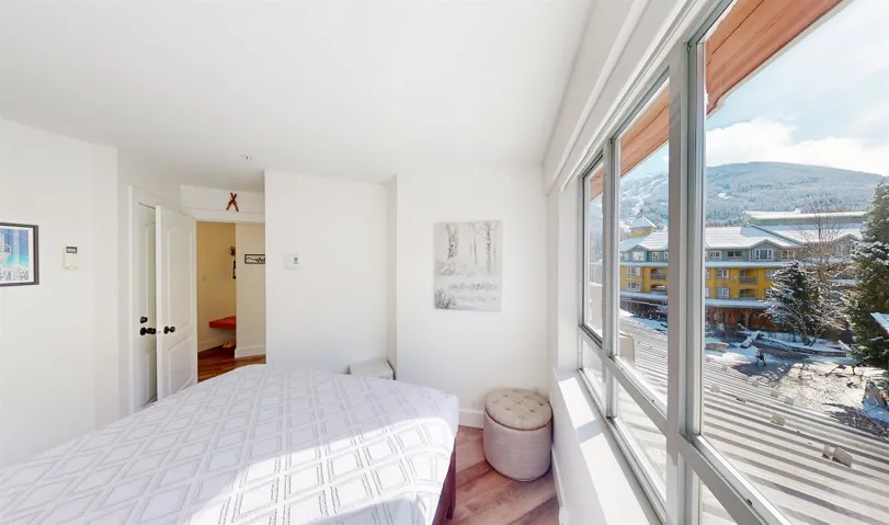 Bedroom with a mountain view and wood finished floors
