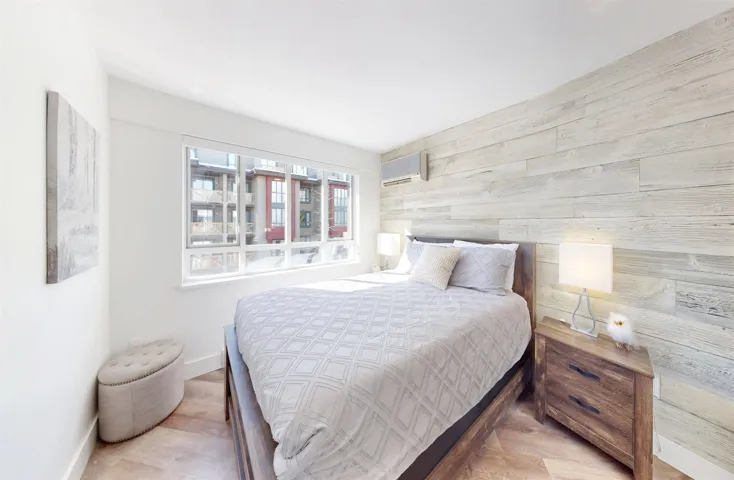 Bedroom featuring wood finished floors and wood walls