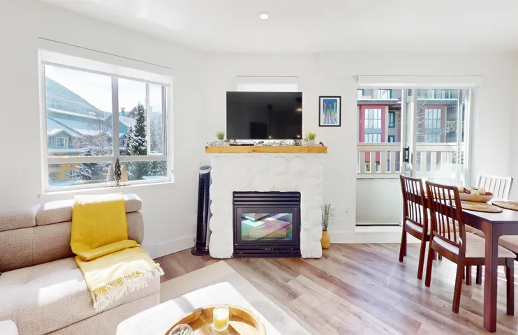 Living area featuring wood finished floors, a fireplace, and recessed lighting