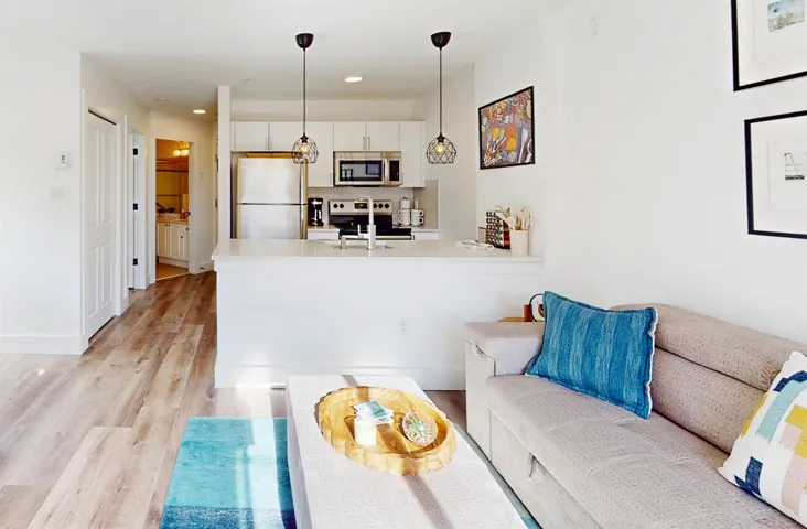 Living room with light wood-style flooring and recessed lighting